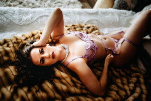 woman in boudoir shoot, woman laying on back, woman in ligerie